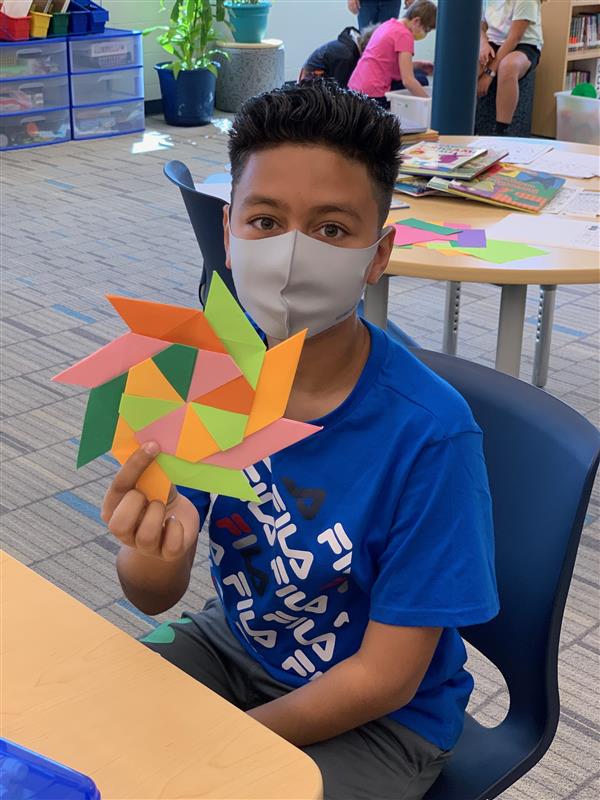  A student shows an origami project created during makerspace rotations.